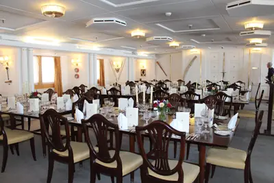 A dining room aboard the Royal Yacht Britannia laid for a formal event