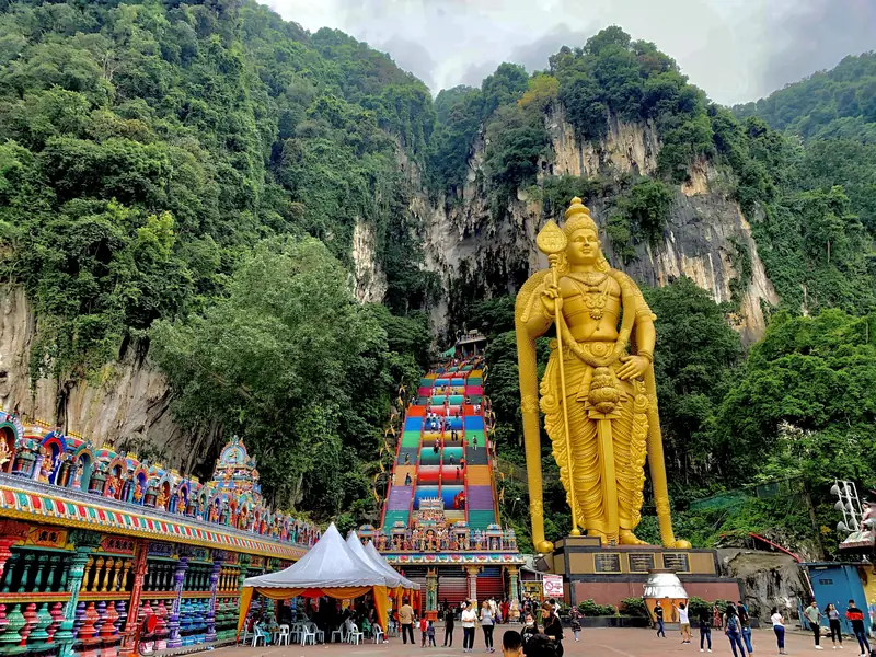 The golden statue of Lord Murugan and the stairway at Batu Caves