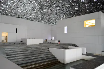 Light filtering through the dome onto the Louvre Abu Dhabi's plaza