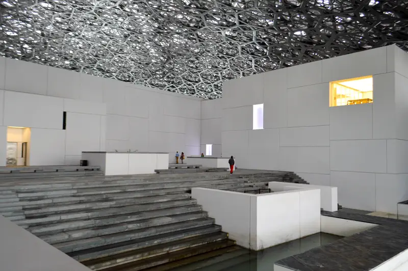 Light filtering through the dome onto the Louvre Abu Dhabi's plaza