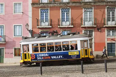 A yellow tram in the Alfama district, Lisbon