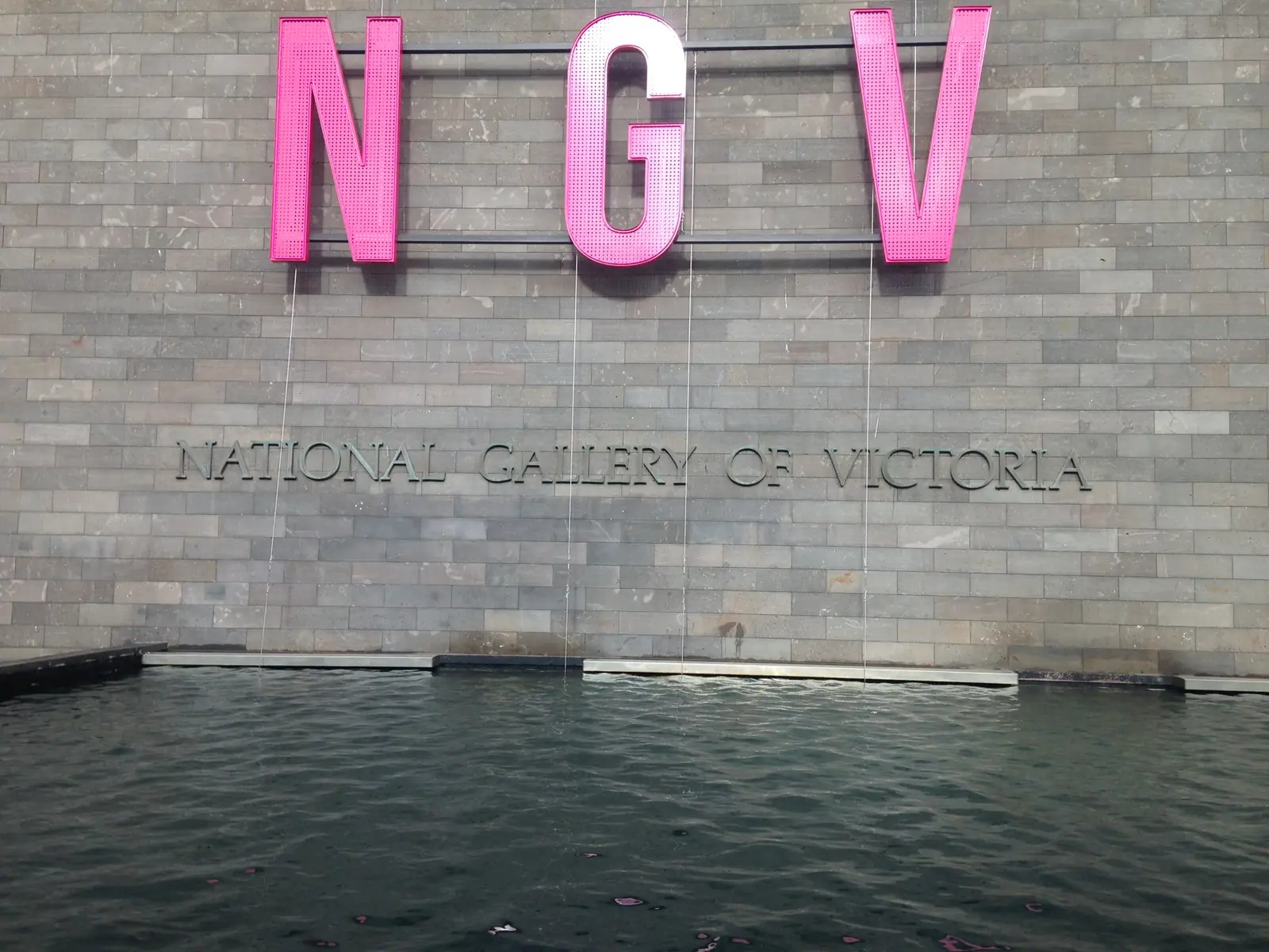The NGV sign by the water wall at NGV International, St Kilda Road, Melbourne
