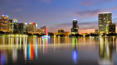Downtown Orlando reflected in Lake Eola at night