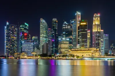 The Singapore skyline lit up at night across Marina Bay